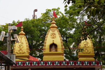 Golden Hindu Temple Domes Surrounded by Green Trees in India