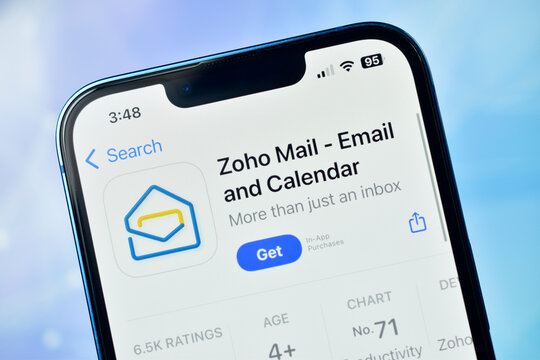 Closeup of iphone screen displaying the zoho mail app download page on an app store