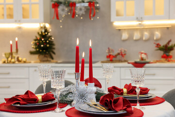 Festive table setting with Christmas decor in kitchen, closeup. Interior design
