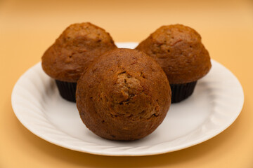 Carrot muffins on a white plate (selective focus)