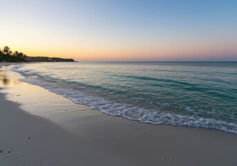 Obraz premium Gentle tropical ocean waves wash onto soft, pristine white sand at dusk, highlighting the natural beauty of the coastal environment, pristine, sunset, calm