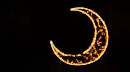 Glowing crescent moon with golden bokeh isolated on black background Yellow Golden gold crescent blur blurred half moon design graphic