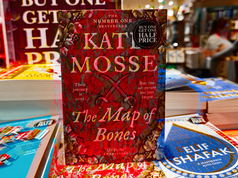 Bookstore display of The Map of Bones by Kate Mosse with other popular novels on colorful shelves