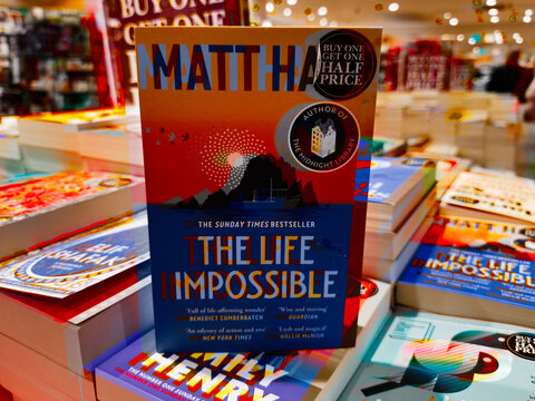 Colorful book on display in bookstore with buy one get one half price promotion