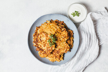 Potato pancakes Latkes on white table background. Traditional Jewish festive food for Hanukkah holiday. Jew festival of lights. Flat lay, top view