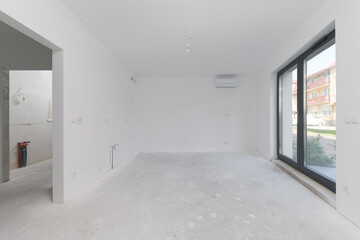 Fototapeta premium Spacious unfinished room interior with window and doorway