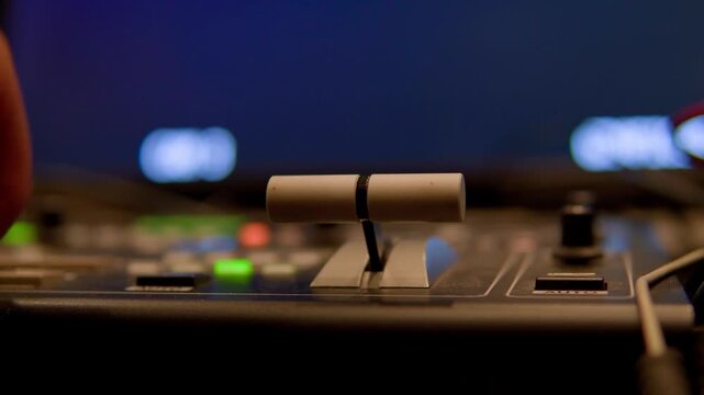 Hand operating a vision mixer switcher for live broadcasting