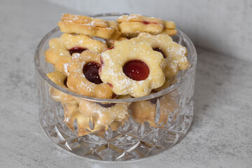 Linzer Cookies with Raspberry Filling in a Glass Bowl