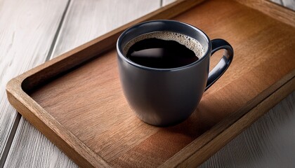 black coffee in a dark mug on wooden tray