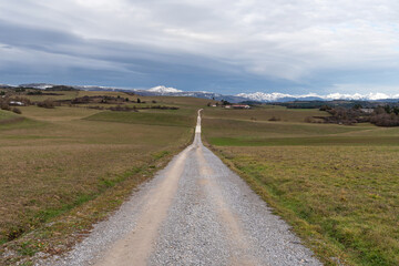 Road towards the snowy peaks of the Navarrese Pyrenees, Abaurrea Alta, Aezkoa Valley