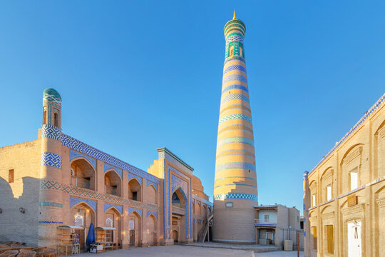 The Islam Khodja Madrasa with its high minaret in the light of dawn, UNESCO World Heritage, Khiva, Uzbekistan