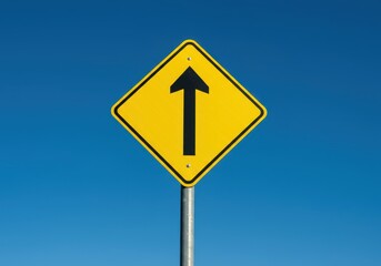 A bright yellow diamond-shaped warning sign indicating a designated area for safe road crossing. High visibility on a clear day setting, zebra, pole, visibility