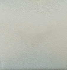 Warm surface with texture covered in white details in minimal light