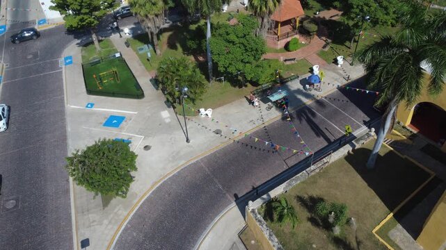 La Ermita, M&eacute;rida, Yucat&aacute;n, Mexico, drone 4K, aerial shot, public park, everyday life, street vendor, gazebo, community activity, tropical greenery, Latin America, cultural area, neighborhood scene, p