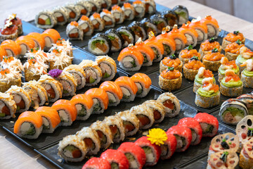 A vibrant array of many different types of gourmet sushi and maki rolls