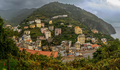 Panoramic view of Riomaggiore taken from a viewpoint on the cliffs of Cinque Terre. The entire...