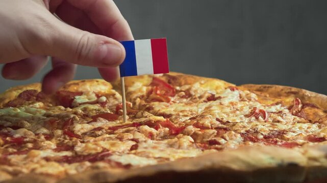 Rotating tomato cheese pizza with French flag, composition emphasizes French dairy traditions and bakery culture used in crust and topping.