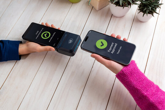 Smartphone and POS terminal display matching payment approval screens, confirming a successful contactless NFC transaction during a modern tap-to-pay mobile payment interaction