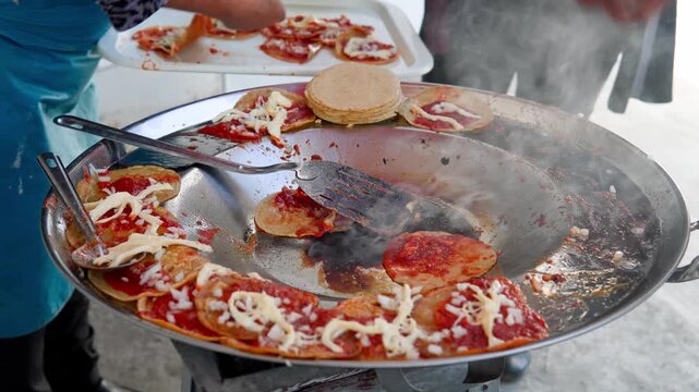 Street food vendors cooking mexican chalupas