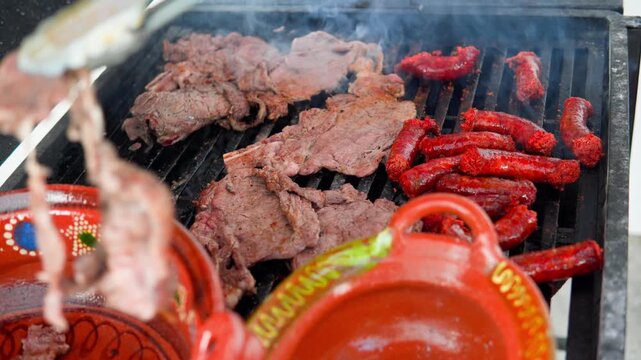 Mexican carne asada and chorizo cooking on a barbecue grill