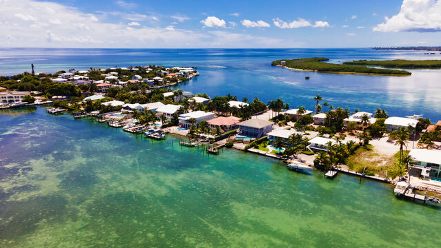 Tropical waterfront neighborhood with docks and clear ocean in Key West