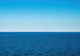 Fototapeta premium The vast blue ocean meets the expansive sky along a crisp, straight horizon line during a calm afternoon, atmosphere, simplicity, space