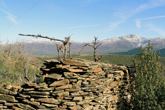 Slate stone wall against a mountainous landscape