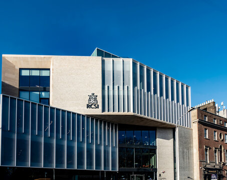 The striking modern entrance of the Royal College of Surgeons (RCSI) on St. Stephen's Green, Dublin, featuring brick, stone, and glass facades.