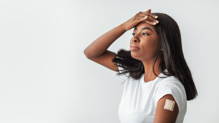 COVID-19 Vaccine Side Effects And Reactions. Portrait Of Young African American Woman Touching Forehead Suffering From Fever High Body Temperature, Banner Panorama With Free Copy Space Isolated Studio