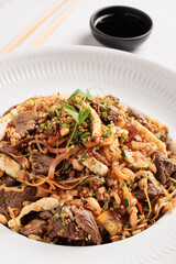 stir-fried beef and vegetable fried rice with egg, peanuts and sesame seeds
