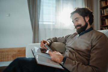Happy man enjoying nostalgic memories looking at album