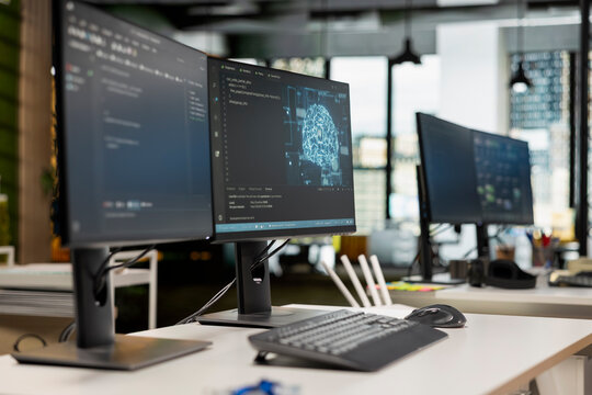PC displays on startup office desk showing deep learning programming languages written by engineers. Computers in AI company workplace used for code testing and quality assurance