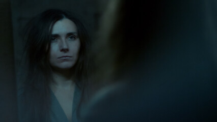 A young woman stares at her reflection in the mirror with confusion and disappointment. A tense emotional moment showing self-doubt, inner struggle, and vulnerability. 