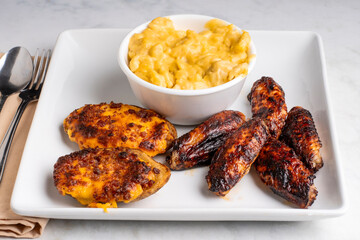 chicken wings with potato skins and mac and cheese