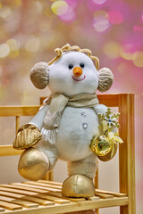 Snowman decoration with golden accents and festive accessories, set against a vibrant bokeh background in a cheerful toy store atmosphere, evoking holiday spirit and joy