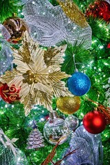 Christmas decorations in selective focus featuring vibrant ornaments, golden poinsettia, and shimmering lights creating a festive atmosphere with bokeh effects for holiday celebrations