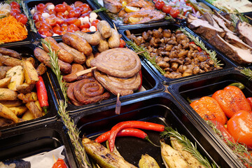 Meat sausages and frankfurters, fried potatoes, vegetables pickle
