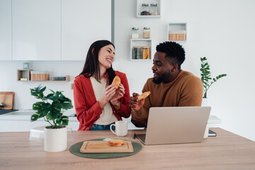 Multiracial couple sharing breakfast during morning routine