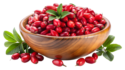 Bright red dogwood cornelian cherries overflow from a rustic wooden bowl with fresh green leaves