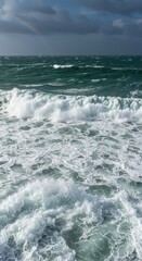 Fototapeta premium Powerful wave action generates a thick layer of sea foam stretching across the wild ocean horizon, resembling a massive white blanket, ocean, horizon, surf