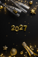 Elegant vertical New Year scene featuring gold 2027 numerals, champagne bottles, glassware and...
