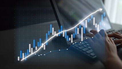 A person analyzes financial data using a laptop, with a graph chart illustrating market trends and growth. Perfect for illustrating business analytics concepts. Copula