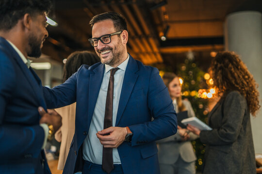 Businessmen networking at an office social gathering - Powered by Adobe