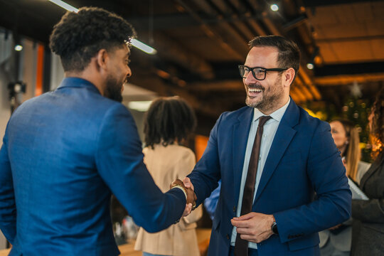 Diverse business professionals handshaking, closing successful corporate project deal - Powered by Adobe