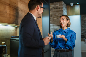 Business colleagues enjoying coffee break while networking and communicating