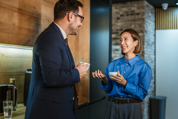Business colleagues enjoying coffee break while networking and communicating