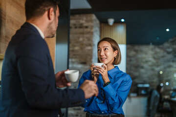 Business colleagues enjoying coffee break while networking and communicating