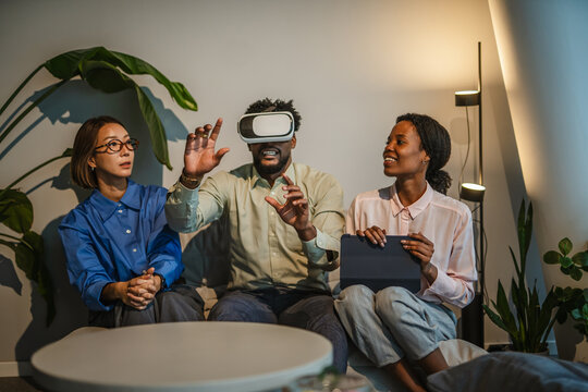 Diverse colleagues exploring virtual reality in modern office - Powered by Adobe