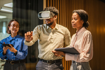 Business colleagues experiencing virtual reality technology in office
