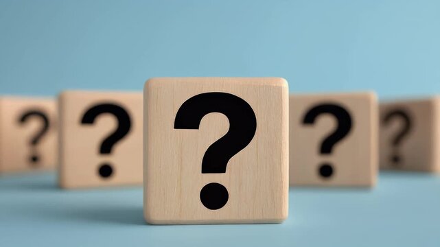 A series of wooden blocks with large question marks on a light blue background, creating a thoughtful atmosphere. great for inquiries, brainstorming, and decis